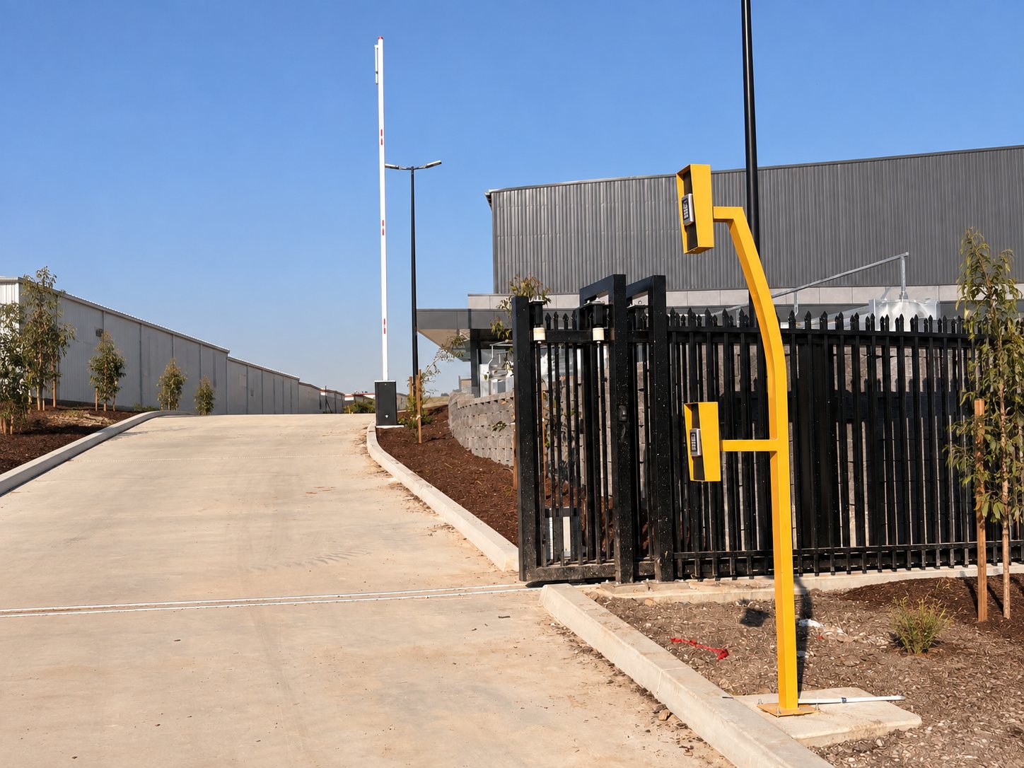 Boom gate at a vehicle entrance